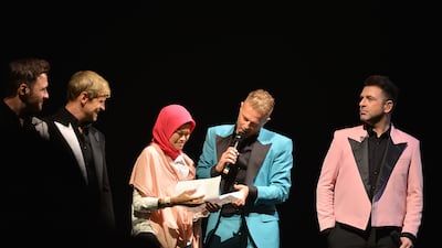 Dian on stage with Westlife during their concert at Etihad Arena.