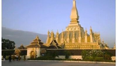 The golden-coloured Pha That Luang Buddhist Stupa in Vientiane, Laos, attracts tourists from around the world. Anders Blomqvist / Getty Images
