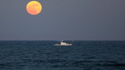 A fishing boat sails as so-called 'Supermoon' rises in Larnaca, Cyprus. Katia Christodoulou / EPA