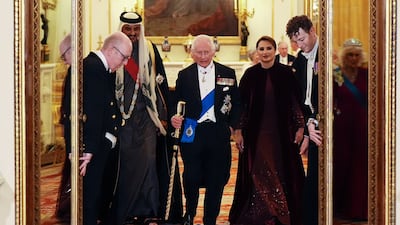 King Charles walks next to Sheikh Tamim and his wife, Sheikha Jawaher. Reuters