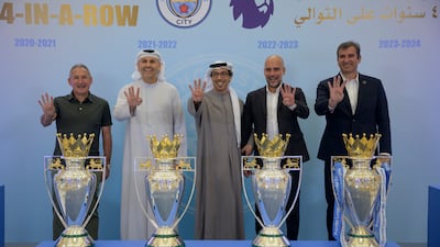 Sheikh Mansour bin Zayed, UAE Vice President and Deputy Prime Minister, centre, stands for a photograph alongside Pep Guardiola, to his right, and other Manchester City officials during an event to celebrate the club’s fourth consecutive Premier League title, at Qasr Al Watan, Abu Dhabi, on June 13, 2024. Photo: UAE Presidential Court