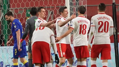 Poland's Robert Lewandowski celebrates with his teammates after scoring the opening goal. AFP