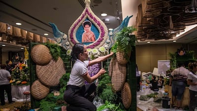 A Thai woman puts together the background to a decoration that will include different vegetable and fruit decorations during a fruit and vegetable carving competition in Bangkok. Robert Schmidt / AFP