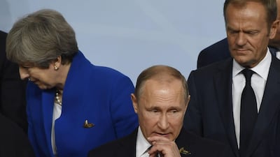 Britain's Prime Minister Theresa May (L) Russia's President Vladimir Putin (C), and President of the European Council Donald Tusk (R) see things differently on the spy poisoning case / AFP PHOTO / Saul LOEB