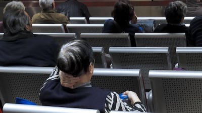 Investors monitor market data at a securities brokerage house in Beijing. EPA