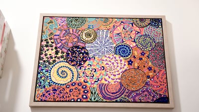 An old scarf was upcycled and framed as a wall hanging