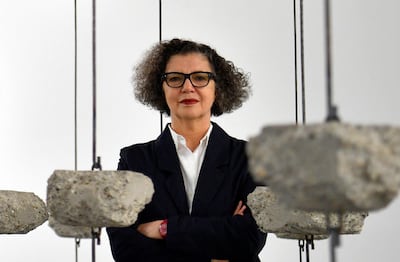 Artist Mona Hatoum poses with her artwork 'Remains to be Seen' as part of a multi-artist show at the White Cube gallery in London. EPA