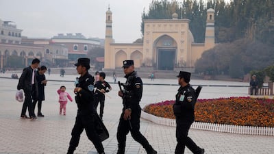Uighur security personnel patrol near the Id Kah Mosque in Kashgar in western China's Xinjiang region in 2017. AP