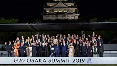 Leaders and their spouses pose for a group photo in front of the Osaka Castle during the G20 Summit in Osaka. AFP