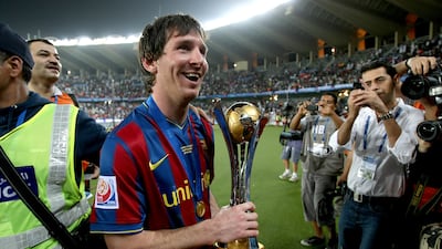 Barcelona's Lionel Messi holds the 2009 FIFA Club World Cup trophy as he celebrates the Spanish club's victory at Zayed Sports City Stadium in Abu Dhabi on December 19, 2009. Photo: AFP