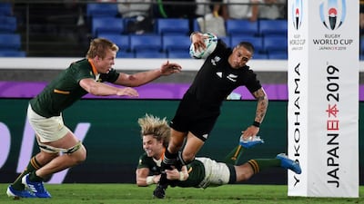 South Africa's scrum-half Faf de Klerk (bottom) tackles New Zealand's scrum-half Aaron Smith (R) beside teammate flanker Pieter-Steph Du Toit (L) during the Japan 2019 Rugby World Cup Pool B match between New Zealand and South Africa at the International Stadium Yokohama in Yokohama. AFP