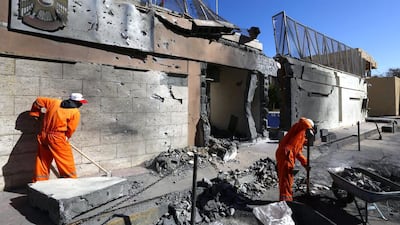Workers clean up outside the UAE embassy in Tripoli after it was targeted by a car bomb on November 13. EPA