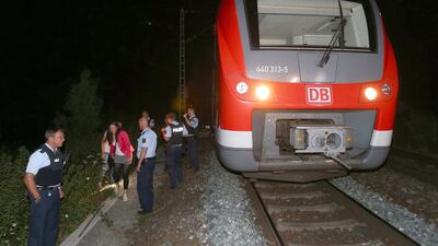 Police stand by the train on which a 17-year-old attacked passengers in Wuerzburg, Germany, on 18 July 2016. Karl-Josef Hildenbrand/EPA
