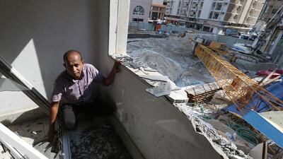 Apartment building doorman Mohammed Sarwat shows the damage caused by the crane’s collapse. Delores Johnson / The National