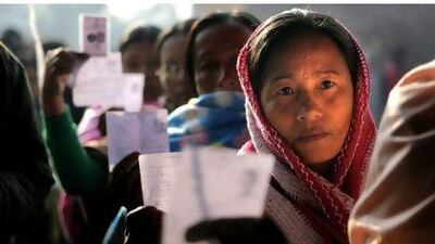 Voters show their election cards yesterday as they queue to cast their votes in a polling station in Thoubal constituency, on the outskirts of Imphal, in the north-east Indian state of Manipur. Anupam Nath / AP Photo