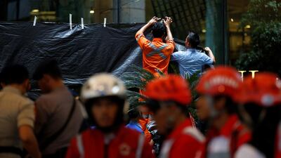 Workers cover a window to block the view inside a building at the Indonesia Stock Exchange following. Darren Whiteside / Reuters
