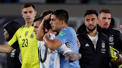 Messi (hugs Uruguay's Luis Suarez at the final whistle. EPA