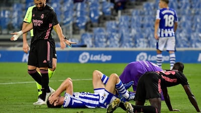 Real Madrid's Karim Benzema reacts next to Real Sociedad's Aritz Elustondo. AP Photo