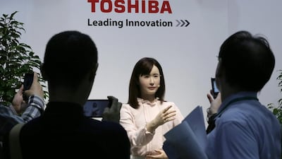 Toshiba's Ms Aiko Chihira, a humanoid communications robot, which uses sign language to communicate and assist elderly people and those with dementia. Kimimasa Mayama / EPA