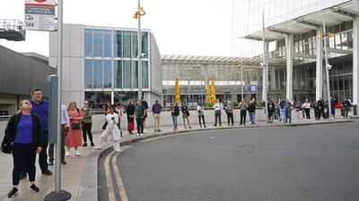 Commuters stand in a queue waiting for a bus at London Bridge station ahead of a strike by bus drivers. PA.