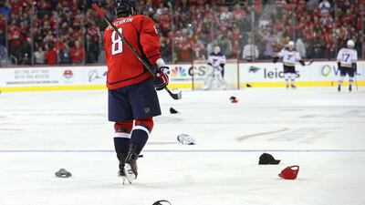 Hats thrown by fans litter the ice in celebration of Alex Ovechkin's hat trick against the St. Louis Blues on November 23, 2016 in Washington, DC. Patrick Smith / AFP