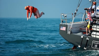 A Team Alvimedica guest jumps off the boat as they depart for the open ocean during the start of Leg 3 to the Volvo Ocean Race from Abu Dhabi to Sanya, China on Saturday. Photo Courtesy / Volvo Ocean Race / Getty Images