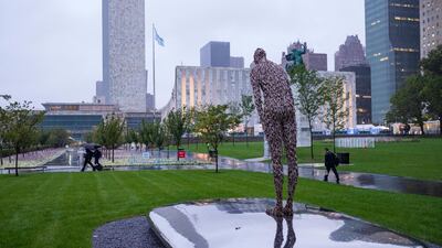 People move along rain soaked walkways at the United Nations headquarters during the 73rd session of the United Nations General Assembly. AP Photo