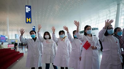 Medical workers wave goodbye to a medical team from Jilin at the Wuhan Tianhe International Airport after travel restrictions were lifted. Reuters