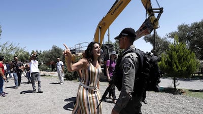 A Palestinian woman argues with Israeli soldiers as they move in to demolish her two-story building used as a house and restaurant in Al Makhour, northwest of Beit Jala, in the West Bank city of Bethlehem. All photos by EPA