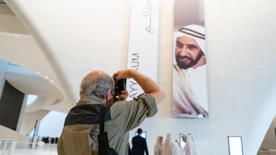 Jack Burlot takes a picture of one of his photographs of Sheikh Zayed, used in a display at the Zayed National Museum. Photo: Ibram Raafat
