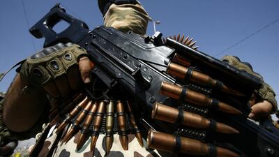 An Iraqi fighter from the Saraya al-Salam (Peace Brigades), a group formed by Iraqi Shiite Muslim cleric Moqtada al-Sadr, takes part in a parade in the central city of Kufa, Iraq. Haidar Hamdani / AFP