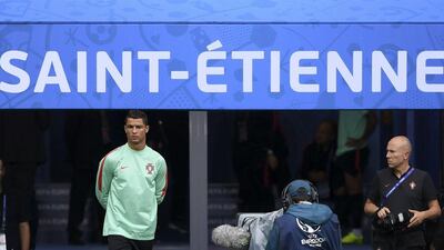 Portugal’s forward Cristiano Ronaldo enters the pict to take part a training session at Geoffroy Guichard stadium in Sait-Etienne on June 13, 2016, on the eve of the match between Portugal and Iceland, during the Uefa Euro 2016 football tornament. Francisco Leong / AFP