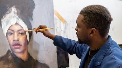 Victor Sitali, an artist from Zambia, works on a painting. Photo: Victor Sitali