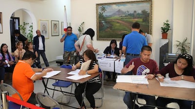 Filipinos learn about candidates before casting their vote on Monday at the Philippine embassy in Abu Dhabi. Ravindranath K / The National