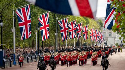 To the sombre notes of a military band, the coffin of Queen Elizabeth II is carried on a horse-drawn gun carriage from Buckingham Palace to Westminster Hall. Reuters