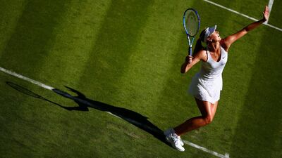 Maria Sharapova serves during her first round victory over Johanna Konta on Monday at the opening day of Wimbledon in London. Julian Finney / Getty Images