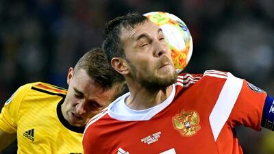 Belgium's Timothy Castagne, left, challenges Russia's Artem Dzyuba. AP Photo