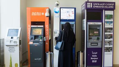 A customer uses an automatic teller machine. Payment processor Network International earned 73 per cent of its first half revenue in 2019 in the Middle East. Reem Mohammed/The National