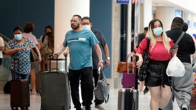 Travellers walk to their destinations at the Los Angeles International Airport. AP