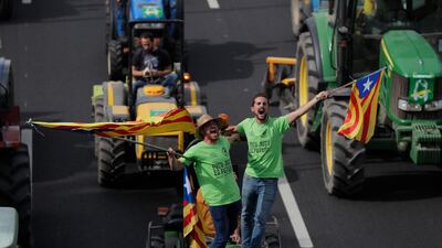 Protesters ride on tractors as they enter the city on the fifth day of protests over the conviction of a dozen Catalan independence leaders in Barcelona, Spain, Friday, October 18, 2019. AP Photo/Manu Fernandez