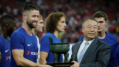 Chelsea's Gary Cahill receives the trophy at the end of the match. Jason Lee / Reuters