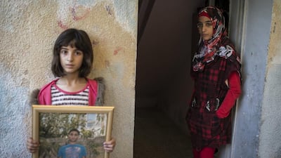 Family members of Abdel Rahman Al-Shaludi, the Palestinian that was killed by Police yesterday after he drove his car into passengers at a rail station causing the death of a 3 month old baby, mourn at the house in Silwan, Israel. The incident occurred at a light rail train station at Ammunition hill, Al-Shaludi drove his car onto the tracks hitting passengers disembarking from the train, injuring seven more people. Ilia Yefimovich / Getty Images