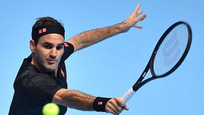 Roger Federer returns a volley against Matteo Berrettini during their ATP Finals match. AFP