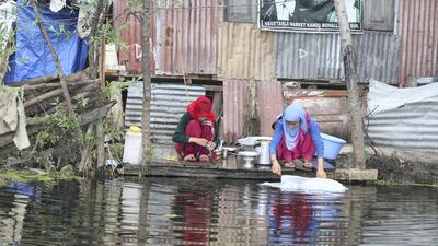 Women washing utensils in the lake. The community is often blamed for polluting the waters with domestic chores and synthetic fertilisers to grow their produce. Priti Salian for The National