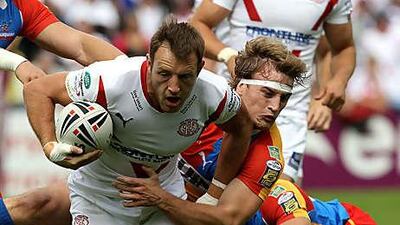 St Helens' James Roby is tackled in the victory over Harlequins yesterday.