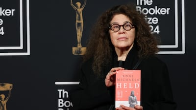 Shortlisted Canadian author Anne Michaels holds a copy of her book 'Held'. EPA