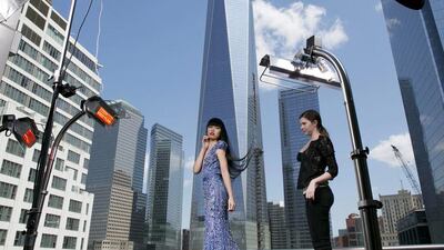 CORRECTS SPELLING OF MODEL’S NAME TO JESSICA MINH ANH INSTEAD OF JESSICA MING AHN — Fashion model Jessica Minh Anh, centre, poses during a photo shoot, with One World Trade Center as a backdrop, Monday, May 19, 2014, in New York. Anh is hosting a fashion show inside New York’s new skyscraper, June 25. (AP Photo/Mark Lennihan)