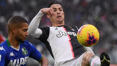 Sassuolo's German defender Jeremy Toljan (L) fights for the ball with Juventus' Portuguese forward Cristiano Ronaldo. AFP