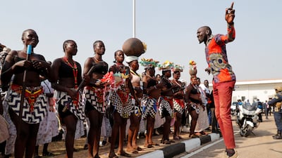 Traditional dancers prepare to welcome the Pope. Reuters