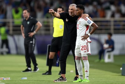UAE head coach Cosmin Olariou with Yahya Al Ghassani during a game against Uzbekistan in World Cup qualifying. Chris Whiteoak / The National